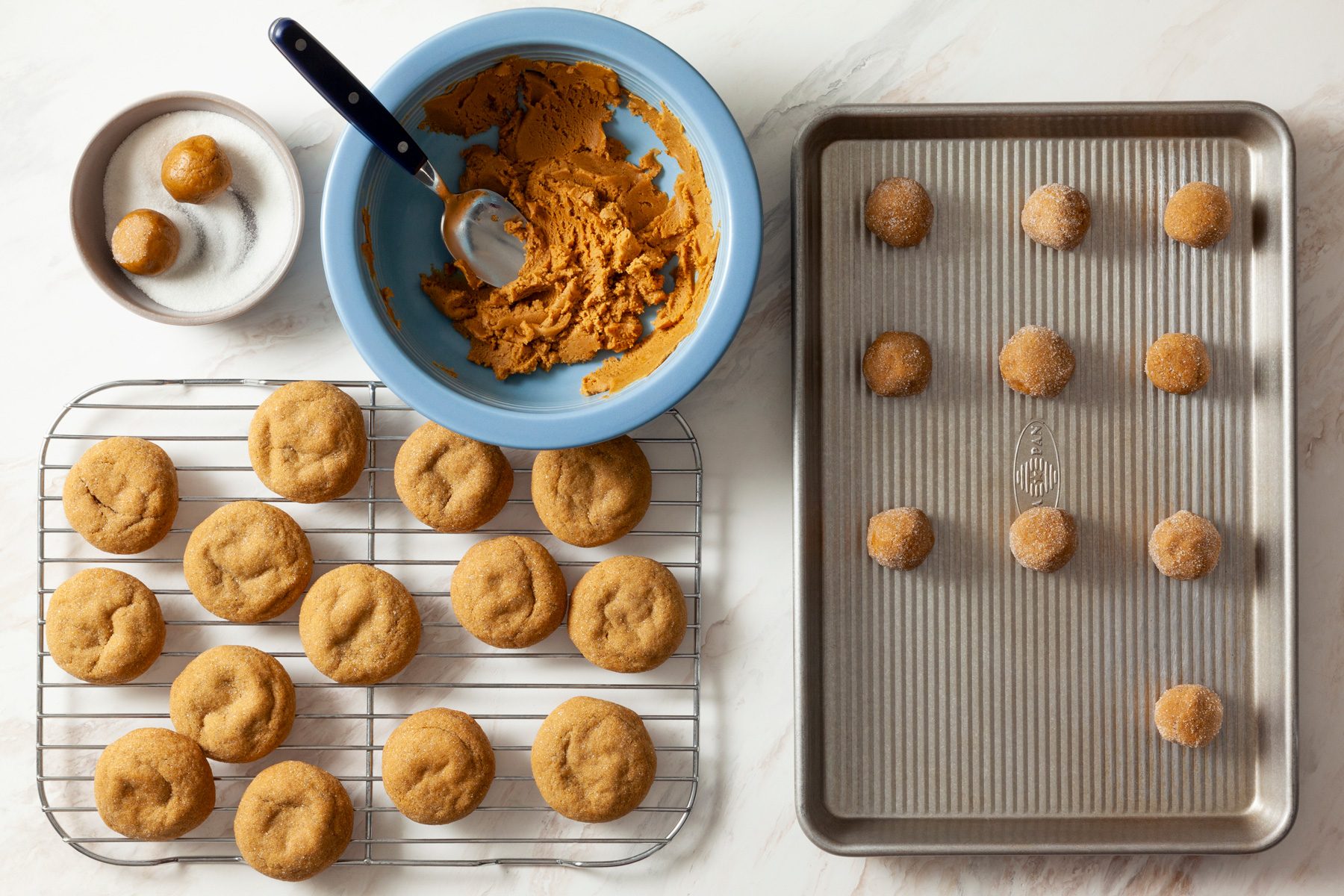 A tray of cookies and a bowl of peanut butter
