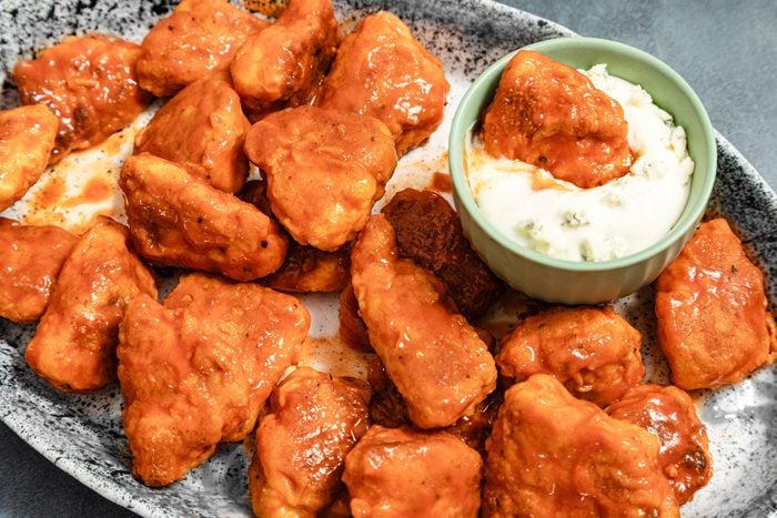 Boneless buffalo wings and ranch dip served in a plate
