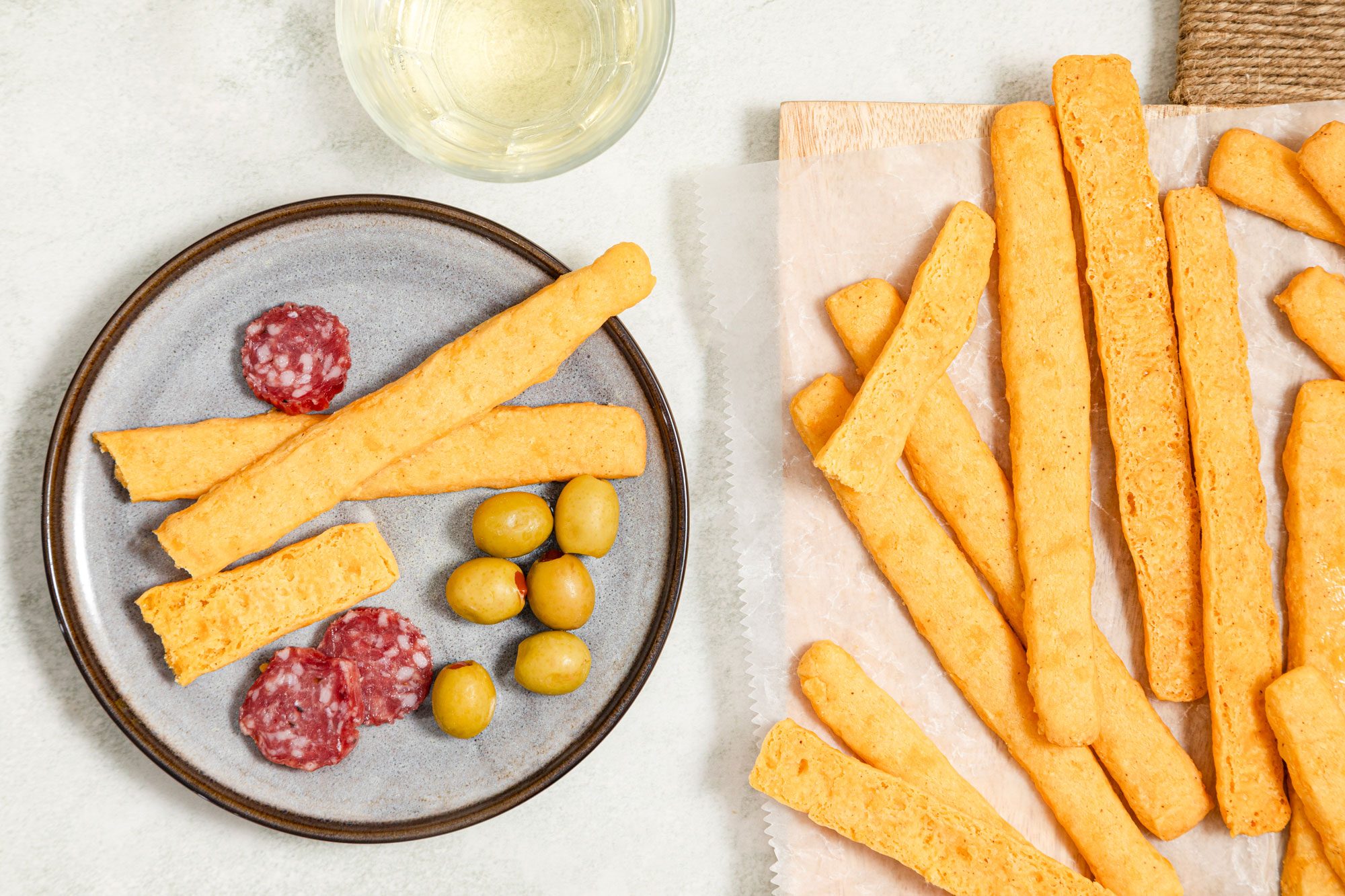 Cheese Straws and olives served in plate on table