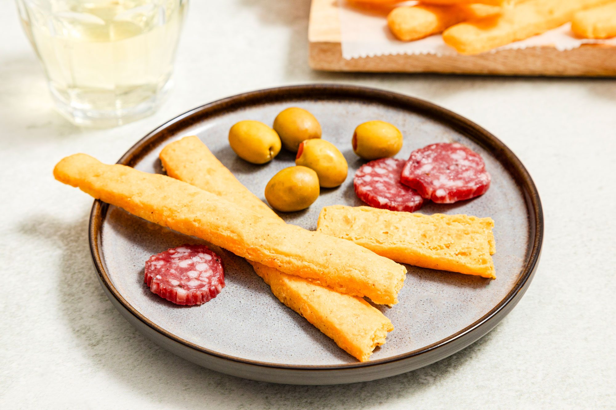 Easy Cheese Straws served in plate with beef and olives