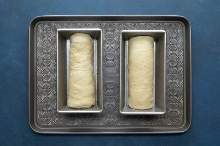 Place the rolled loaves in two prepared loaf pans