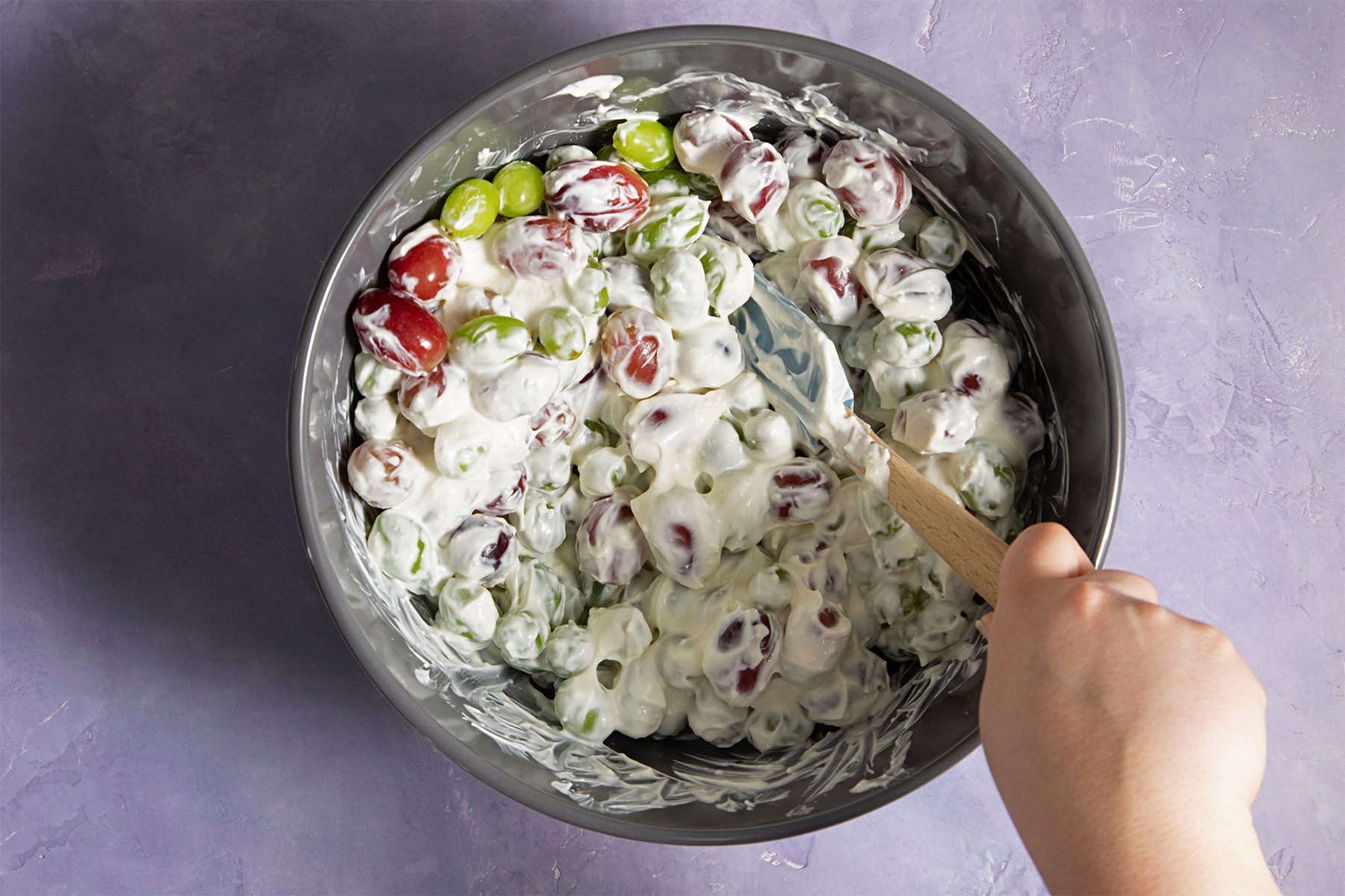 tossing the grapes for Creamy Grape Salad 