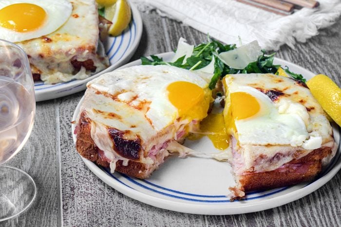Croque Madame served on a plate on a wooden surface