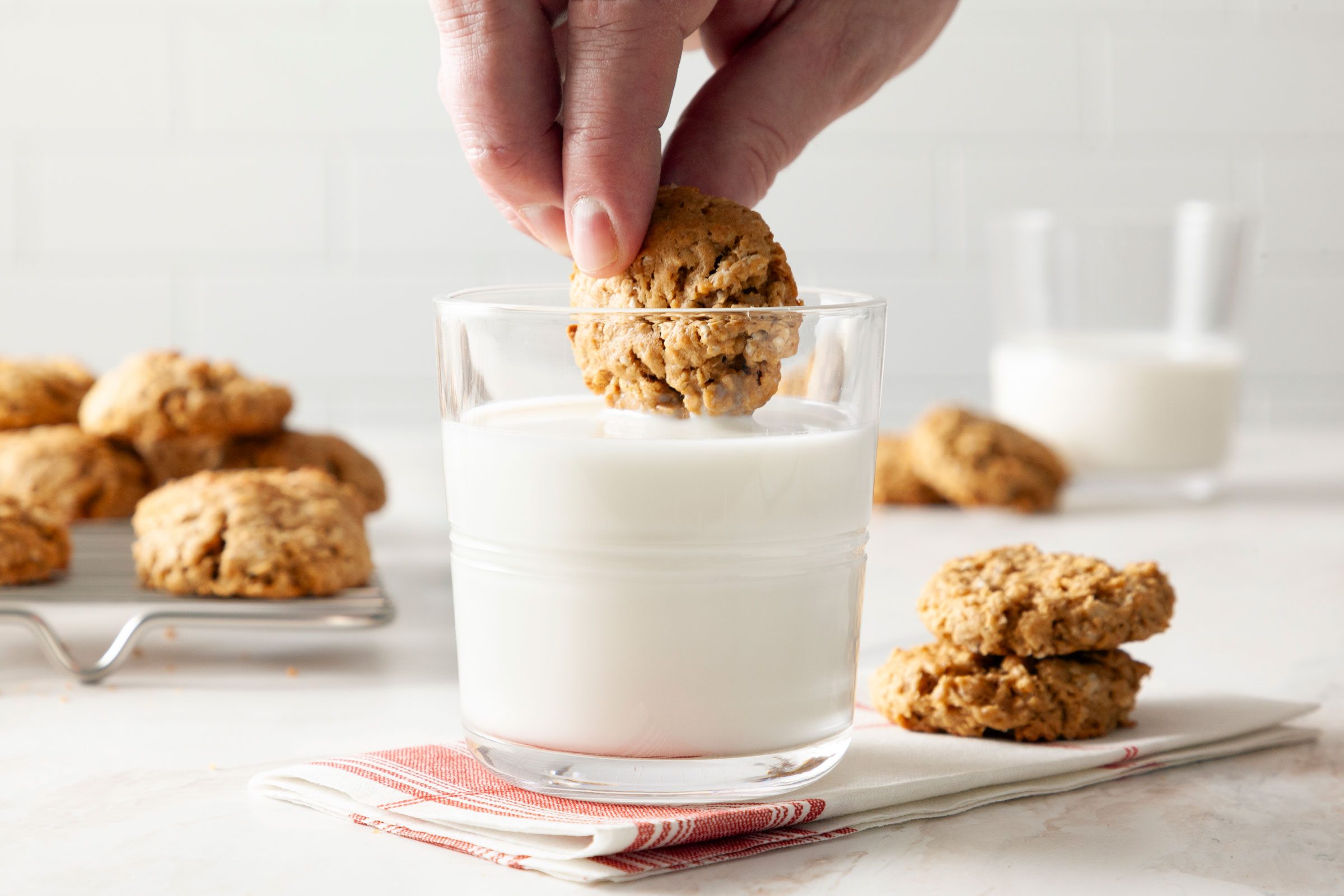 dipping a Peanut Butter Oatmeal Cookie into a glass of milk