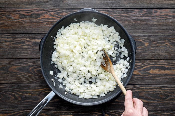 Cooking the diced onions in a large skillet