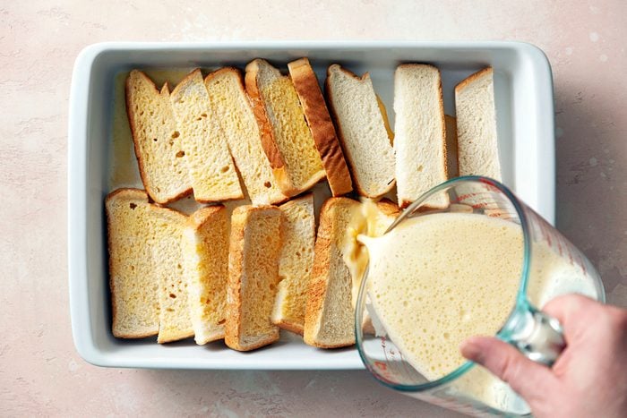 Pouring liquid mixture over slices of bread