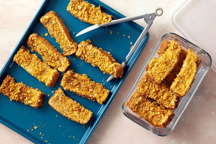 French Toast Sticks on baking tray and in container