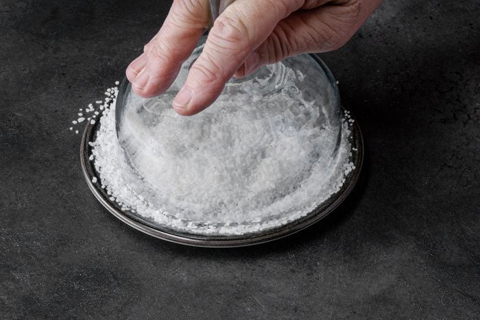 Dipping the rim of the glass in salt