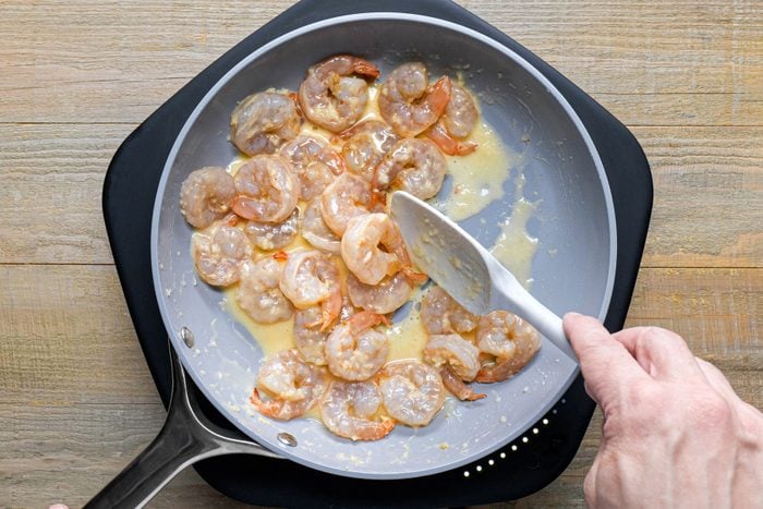 Cooking shrimp with butter in a large skillet