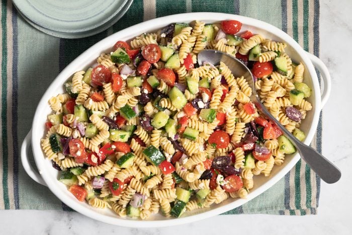 Greek Pasta Salad in a plate served on a kitchen countertop