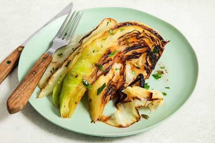 Grilled Cabbage served on a plate with fork
