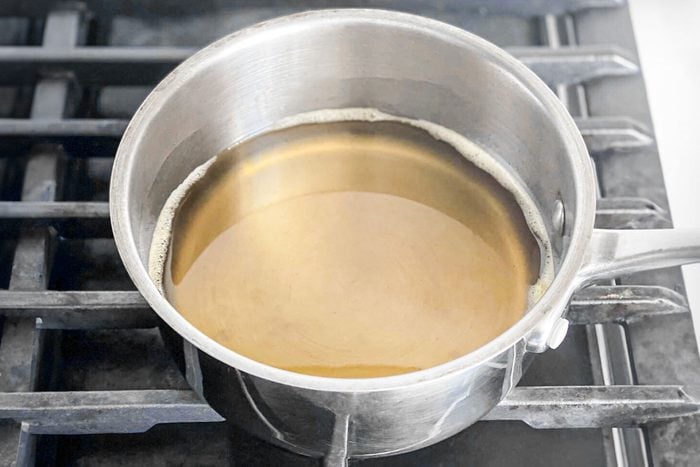 sugar syrup in a saucepan placed on a gas stove