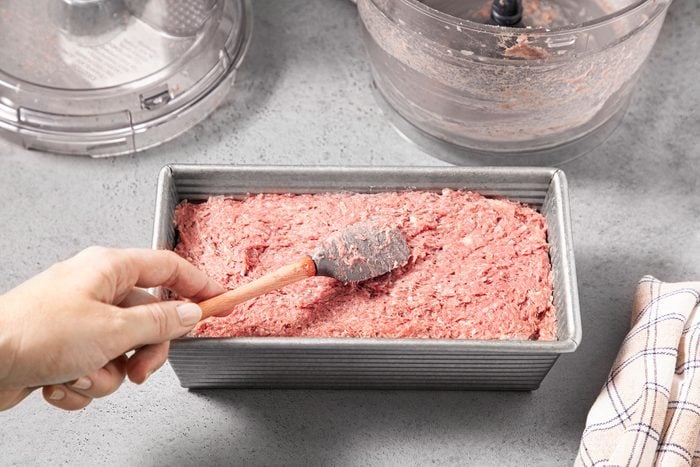 Pressing meat mixture in baking dish