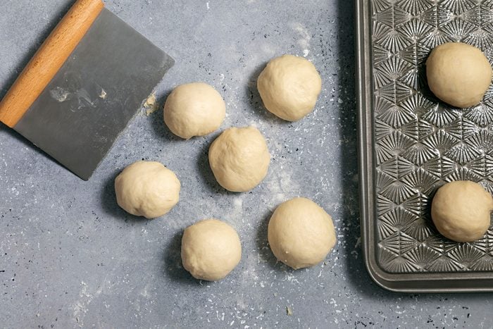 Dough balls on surface and baking tray
