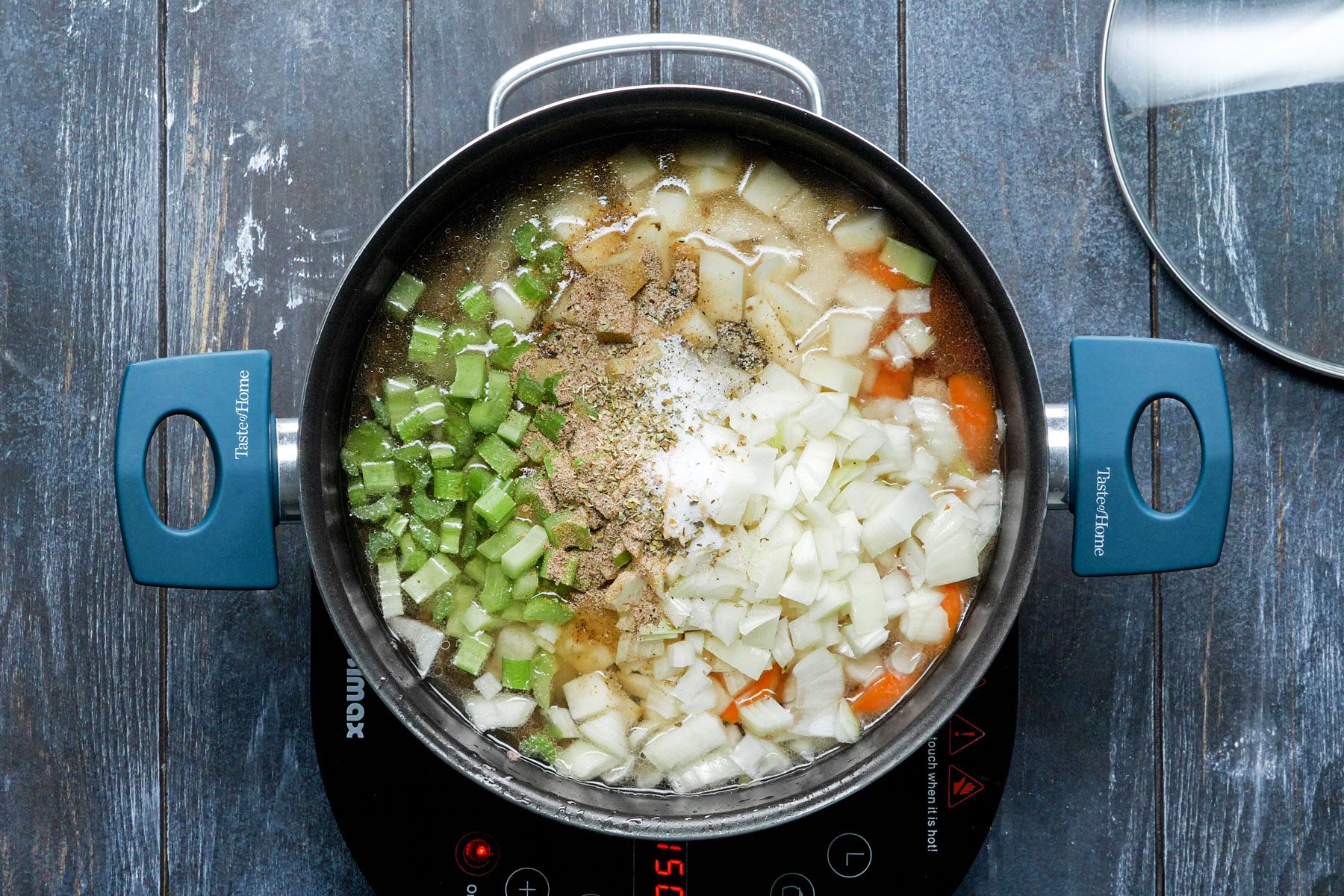 Mixing water, carrots, potatoes, onion, celery, beef bouillon granules in a large saucepan 