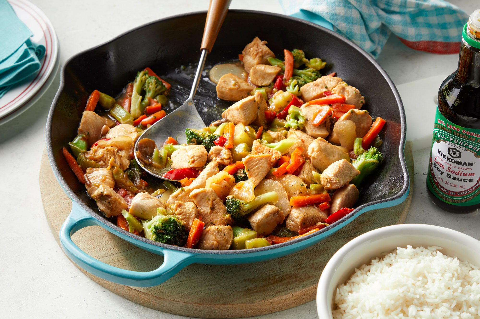 Honey Chicken Stir-Fry in a pan and a bowl of rice placed next to it.