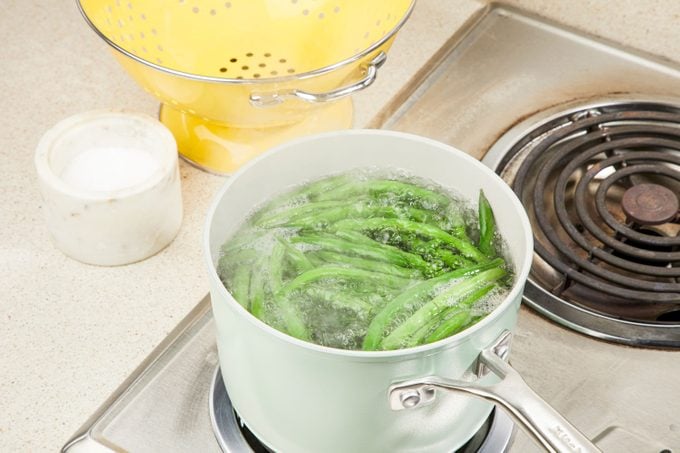 green beans added to boiling pot of water