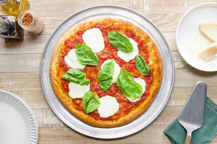 A margherita pizza on a pan
