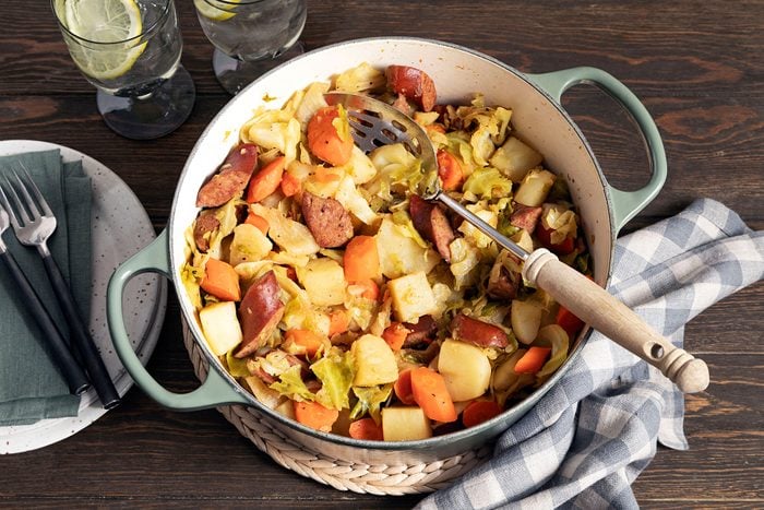 Sausage, Cabbage And Potatoes in Pot with wooden spoon