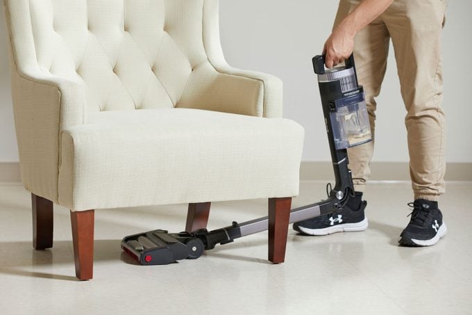 Using Shark vacuum to clean under the furniture