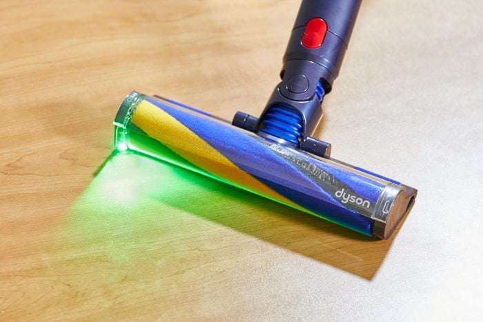 A green LED light on the head of Dyson vacuum 