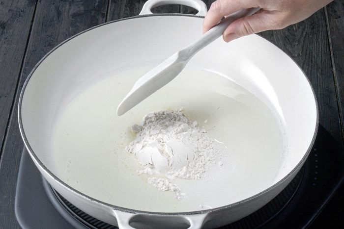 Stirring flour in large skillet over heat