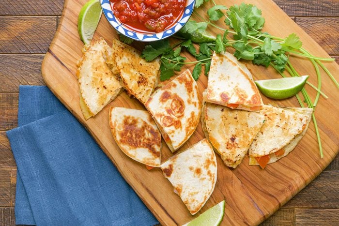 Shrimp quesadillas served with a side bowl of salsa