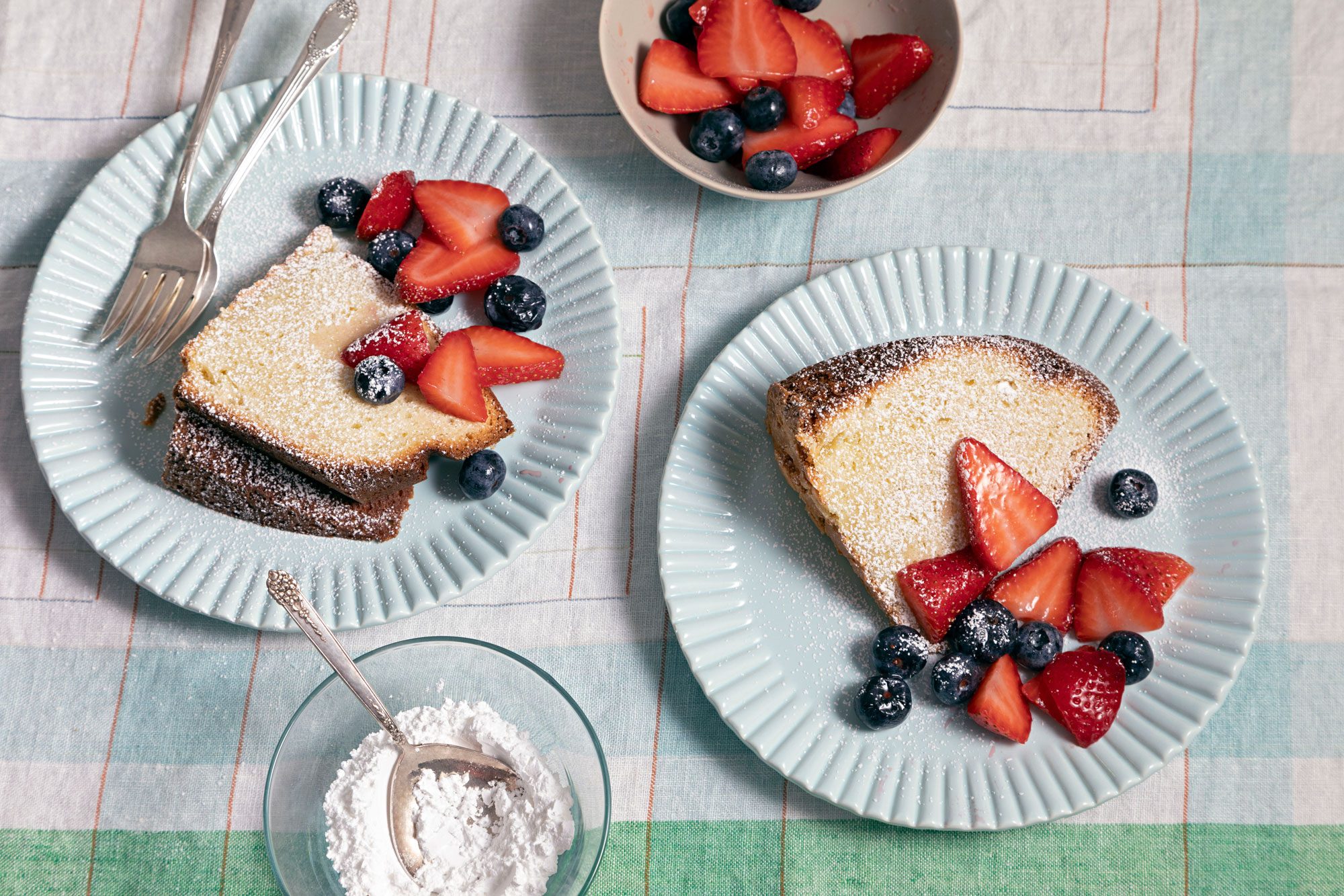 Berry-topped Sour Cream Pound Cake on elegant white plates