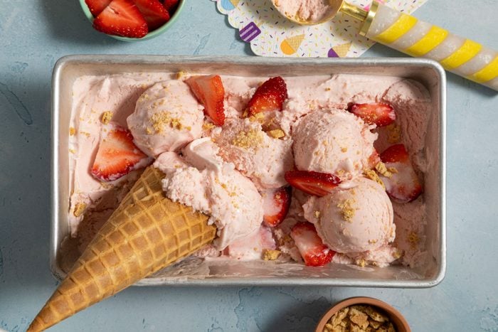 Strawberry Cheesecake Ice Cream with cone and strawberries 