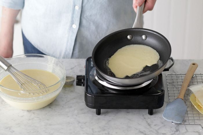 In a large bowl, whisk the eggs, milk, water and melted butter