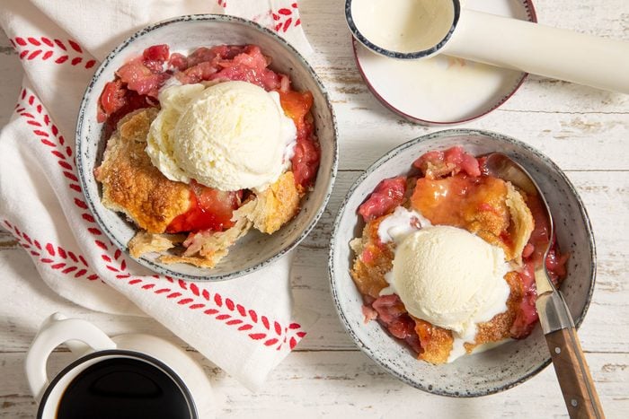 Strawberry Rhubarb Cobbler served with scoops of vanilla ice cream