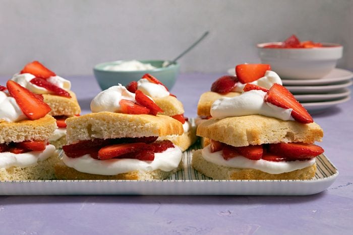 A delicious strawberry shortcake topped with fresh strawberries and whipped cream