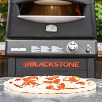 Blackstone Pizza Oven with pizza in front