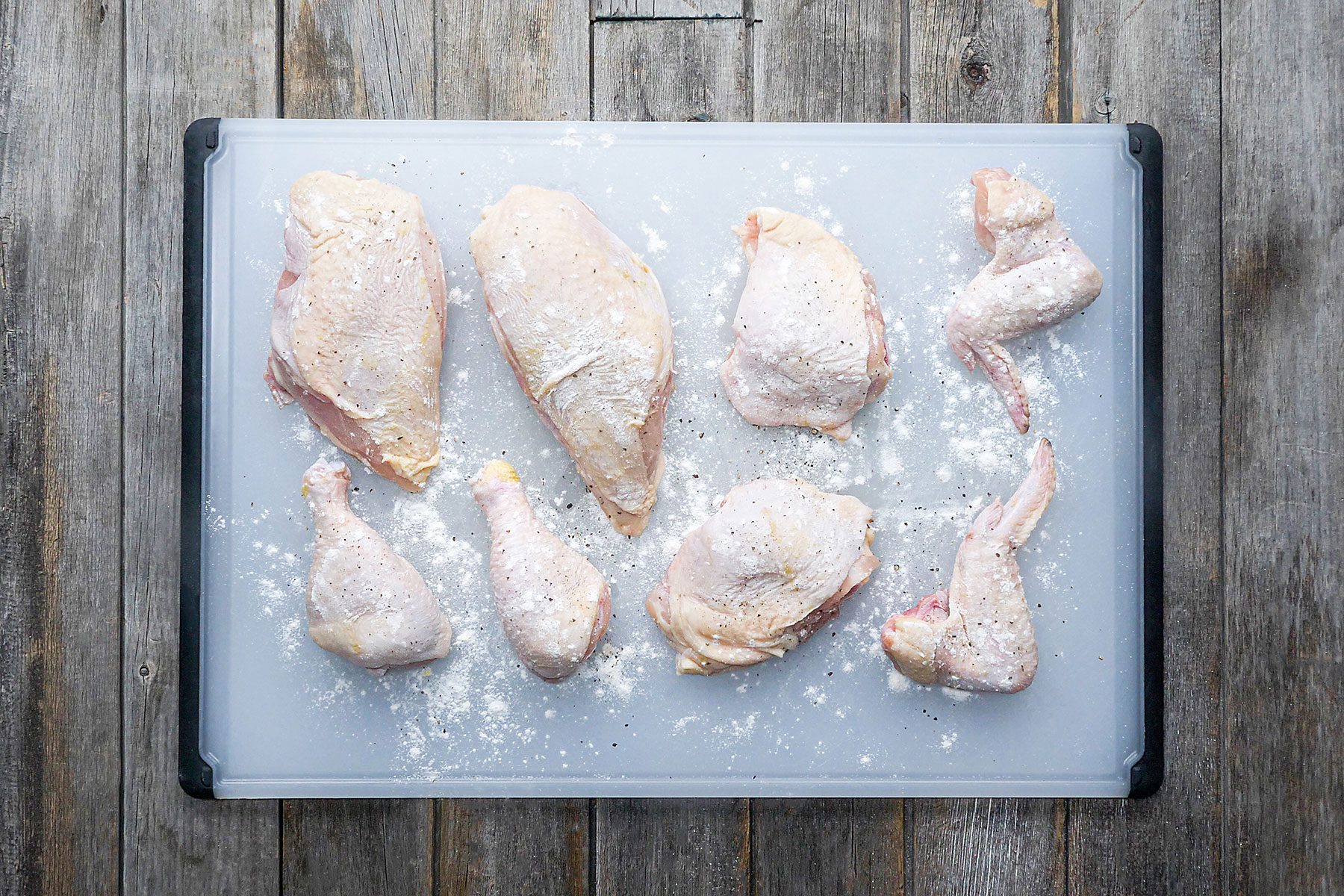 Flour Covered pieces of chicken on cutting board