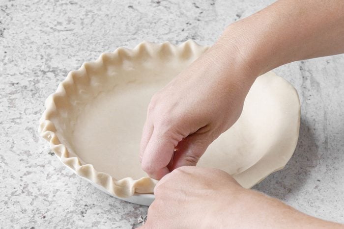 draping the dough in baking pan