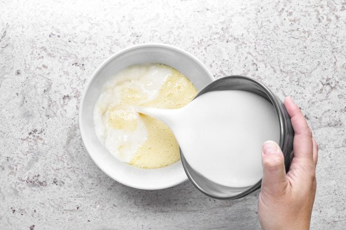 Pouring milk in large bowl