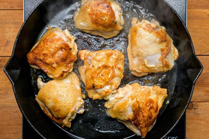 Chicken cooking in skillet