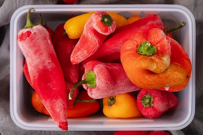 Plastic containers with frozen bell peppers.
