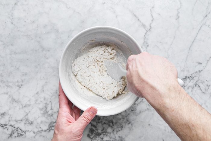 Mixing dough with spatula in a bowl 