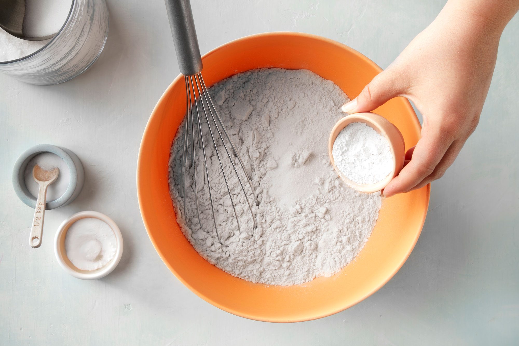 overhead shot of baking powder mixed in the flour in a large bowl