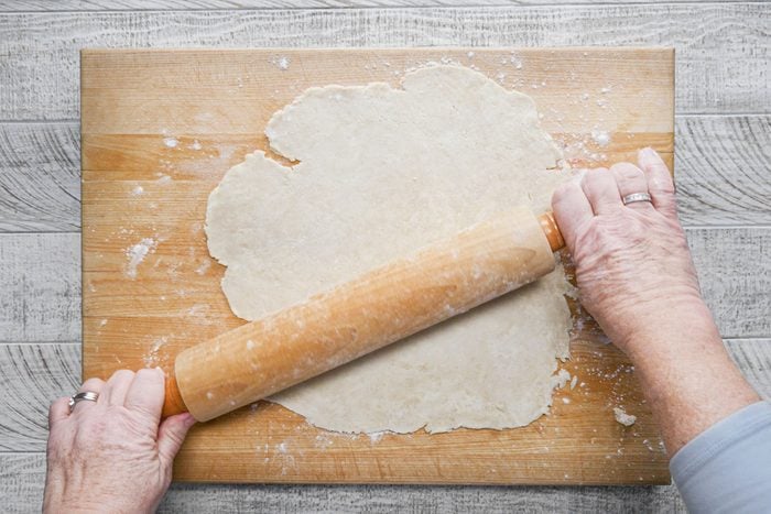 Rolling out dough on wooden board