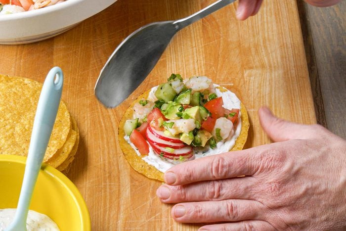 Top the tostada with shrimp and vegetable mixture
