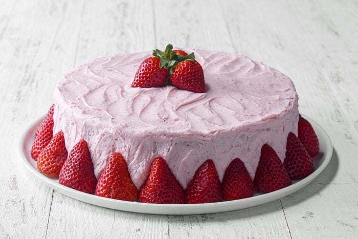 Strawberry Cake garnished with strawberries and served 
