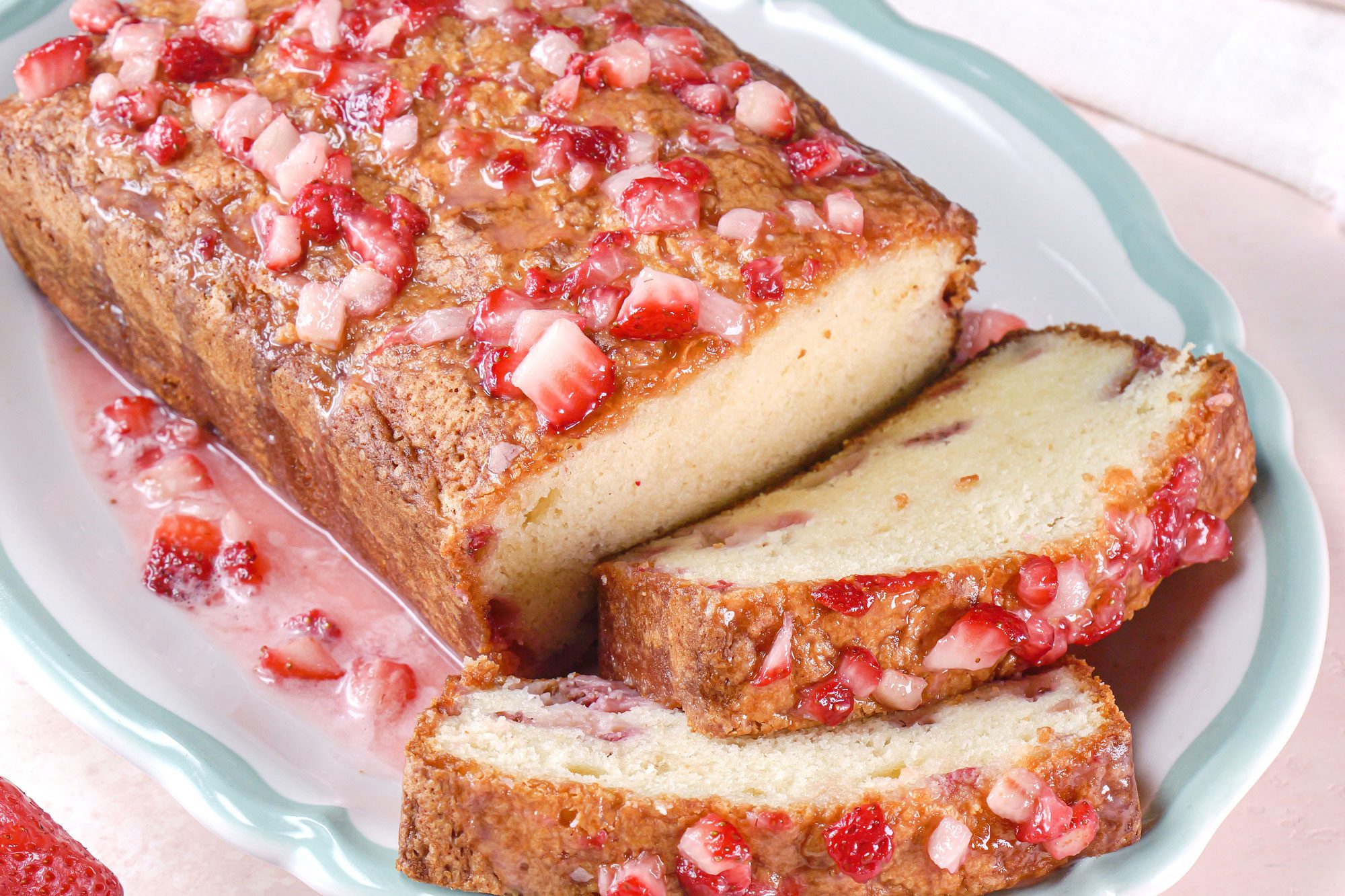 A delicious sliced loaf of Strawberry Pound Cake on a plate