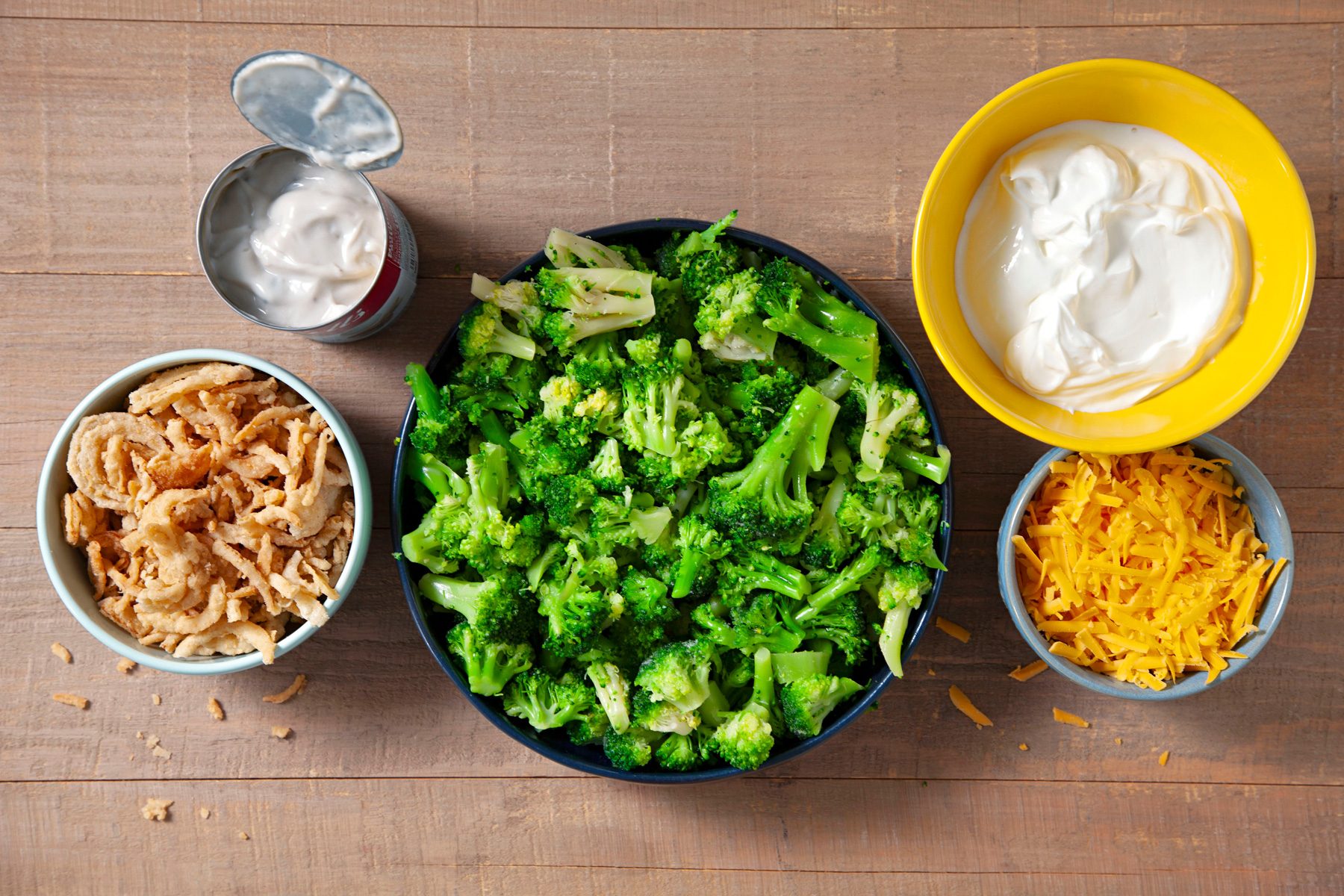 A bowl of broccoli, cheddar cheese and other ingredients