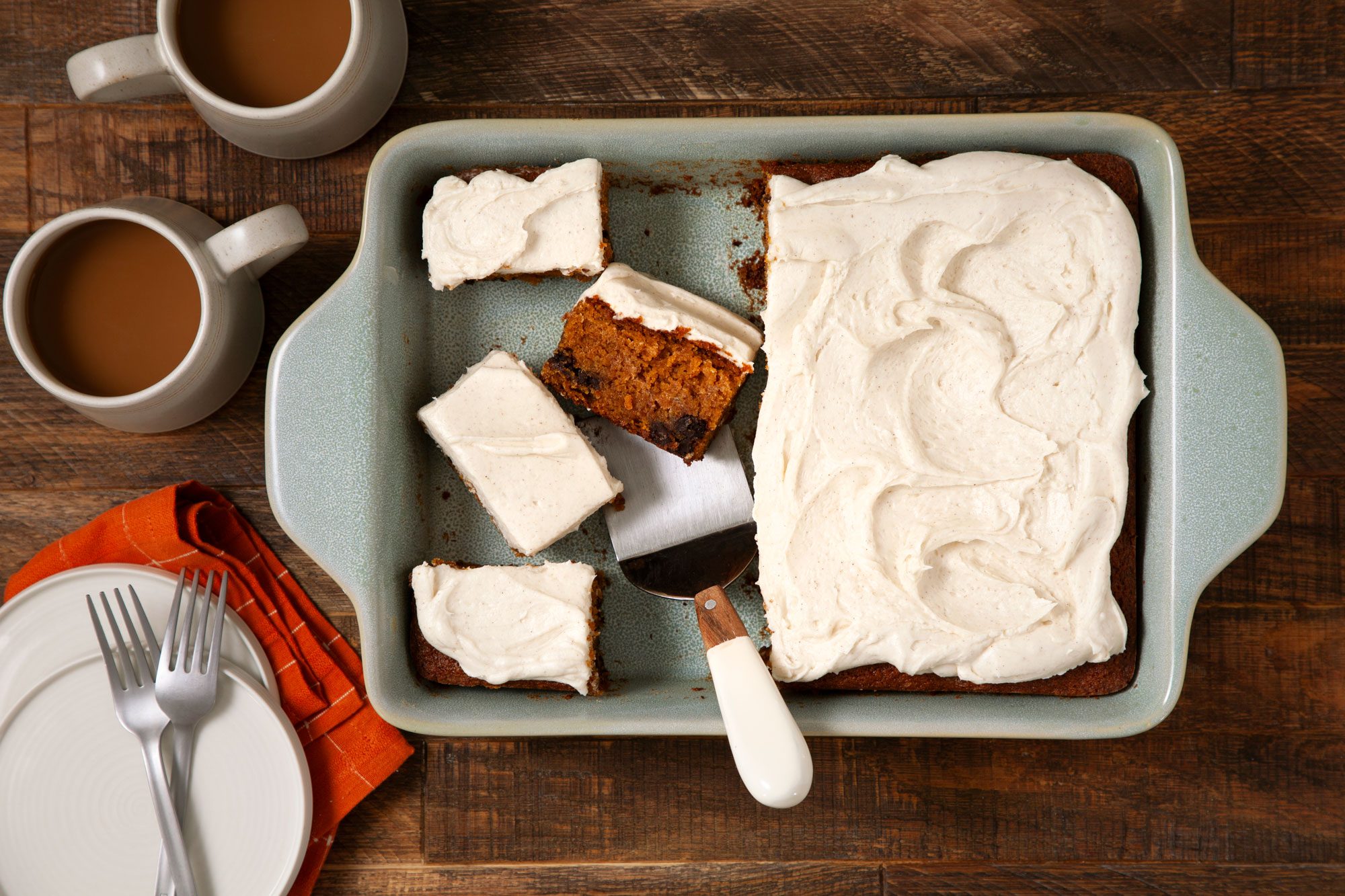 overhead shot of Pumpkin Bars in a baking dish on wooden surface